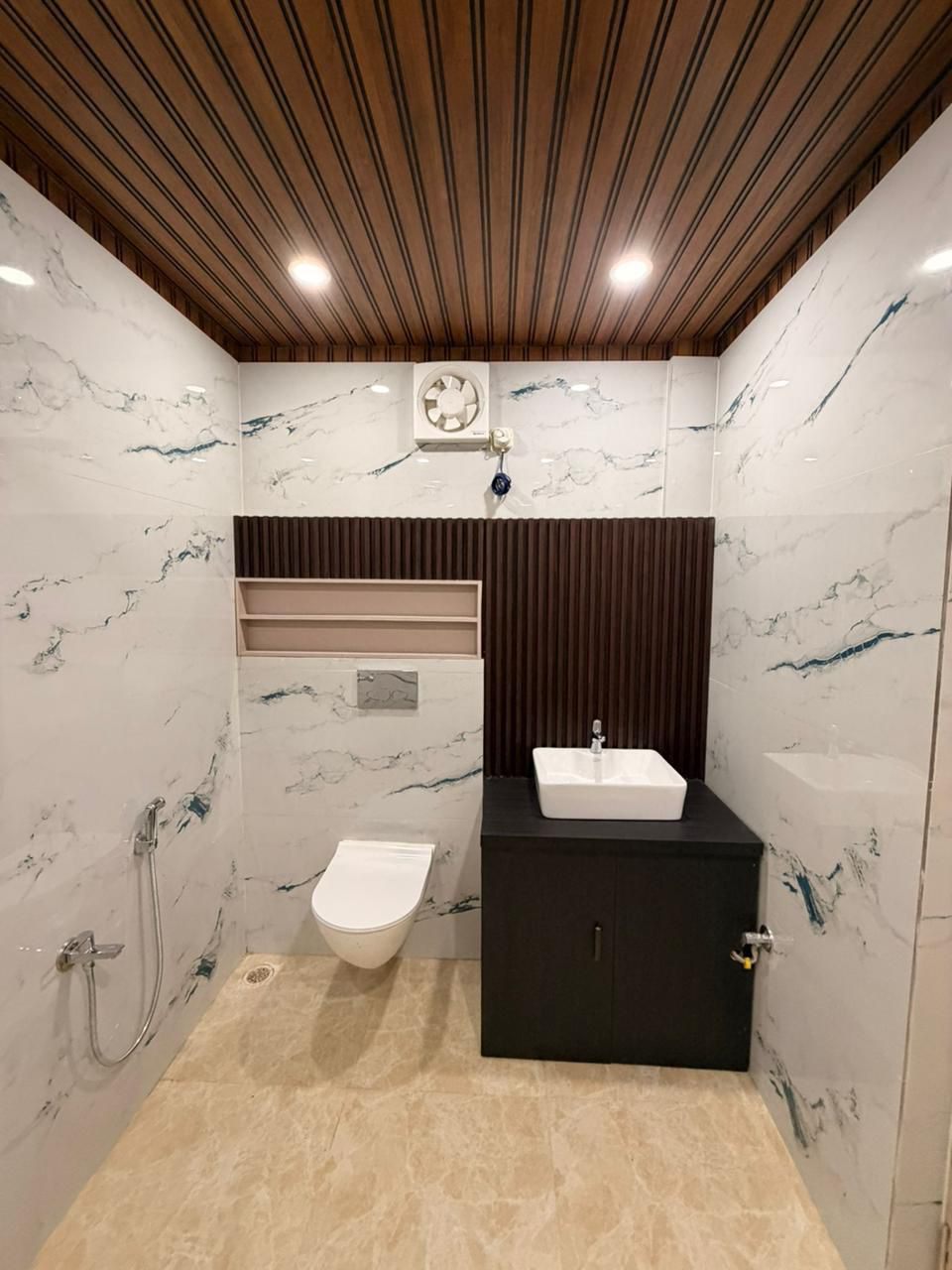 Designer bathroom in marble-finish tile — The Silapathar Residence, Silapathar, Assam